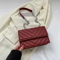 Deep red striped leather small crossbody bag with silver chain strap and V-quilt texture - Red