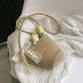 Beige woven straw bucket bag with delicate white lace bow and elegant pearl accent - With Scarf Style / Khaki