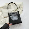 Glossy black leather shoulder bag with striv and optimism text print on a blazer - Letter Style / Black