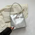 Silver metallic shoulder bag featuring pink butterfly embroidery and a Y2K aesthetic style - Butterfly Design / Silver