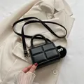 Black quilted mini crossbody bag with top handle and plush eye charm accessory - With Pendant / Black