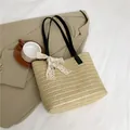 Large woven straw tote bag in beige with black shoulder straps and white lace bow detail - Black