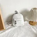 Mini corduroy backpack in pure white with front zipper pocket and minimalist straps - White