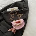 Pink semi-circle saddle bag with gold chain and red cherry decorative buckle - Pink