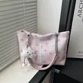 Pink floral tote bag with chain strap and fluffy cloud charm in natural light setting - With Pendant / Pink