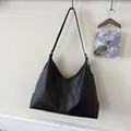 Minimalist black matte leather hobo tote bag with vertical stitching and wide strap - Black