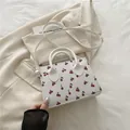 White cherry print pillow bag with dual handles and slender crossbody strap - White