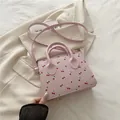 Pink trendy cherry print mini pillow bag with top handles and adjustable shoulder strap - Pink