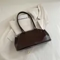 Minimalist deep brown glossy shoulder bag in polished finish with long straps - Brown