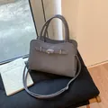Dark grey lychee grain leather handbag with silver twist lock and trapezoid shape - Gray