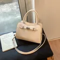 Cream-white lychee grain leather handbag with wavy edge and silver metal buckle - White