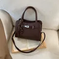 Classic dark brown pebble leather handbag with silver buckle and striped tassel detail - Coffee with Pendant