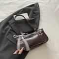 Dark brown leather shoulder bag with vintage lace bow detail and metallic rivets - Brown