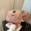 Pink nylon crossbody travel makeup bag with adjustable wide strap and dual zipper closure - Pink