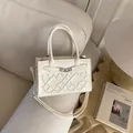 Elegant cream white crossbody bag with diamond embroidery and silver twist lock on sofa - White