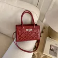Elegant burgundy leather crossbody bag with crown embroidery and silver twist lock detail - Red