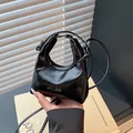 Mini black patent leather crossbody handbag with round handle and silver HYLLZZA logo - Black