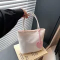 Minimalist white nylon tote bag with pink heart pendant in natural sunlight shadow - White
