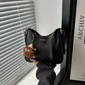 Classic black PU leather bucket bag with fashion label and brown plush monster charm - Pom-pom Ornament / Black