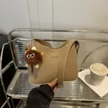 Khaki retro bucket bag with cute plush monster charm and smooth PU leather finish - Pom-pom Ornament / Khaki