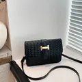 Chic black woven leather crossbody bag featuring a golden H-shaped metal buckle - Black