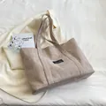 Minimalist khaki canvas tote bag with black fashion label on clean white background - Khaki
