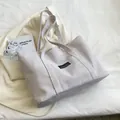 Minimalist light gray canvas tote bag with a small black fashion label for women - Off White