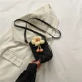 Mini daisy jacquard crossbody phone bag in black with 3D yellow flower and pink pompom - Black
