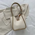 Chic cream tote bag with brown handles and orange printed silk scarf accessory - White