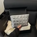 Silver quilted cosmetic bag with metallic finish and zipper in a gift-ready setting - Silver