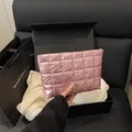 Pink quilted cosmetic bag with metallic finish and black zipper inside a luxury gift box - Pink