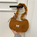 Brown faux suede underarm bag with silver butterfly buckle and ruched shoulder strap - Brown