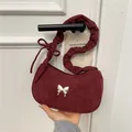 Burgundy suede underarm bag with gold butterfly clasp and pleated shoulder strap - Red