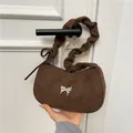 Dark brown suede underarm bag with silver butterfly accent and ruffled cloud strap - Brown
