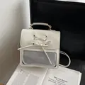 Creamy white PU leather backpack featuring a transparent window and ribbon bow detail - White