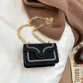Chic black shoulder bag with white wavy stitching and a gold chain strap detail - Black