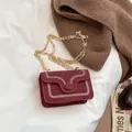 Chic burgundy suede crossbody bag with white embroidery and golden chain strap - Red