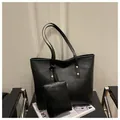 Detail view of black pleated tote bag with golden metal rivets and matching pouch set - Black