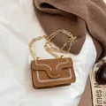 Brown suede crossbody bag with decorative white stitching and gold chain strap - Brown