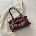 Glossy deep burgundy leather shoulder bag with vintage gold buckle and eyelet strap - Red