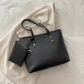 Minimalist black pebbled leather tote bag with matching zippered pouch and slim straps - Black