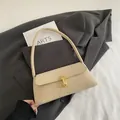 Chic beige leather baguette shoulder bag with gold metal buckle and flap closure - Khaki