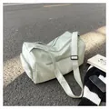 Detail of light green duffel bag showing water-resistant fabric and adjustable strap - Green