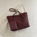 Burgundy leopard print large tote bag with matching coin purse on a cream blazer background - Red