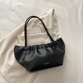 Elegant black PU tote bag with ruffled edges and golden fashion text on chic beige blazer - Black