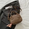 Vintage dark brown shell crossbody bag with embossed logo and elegant oil leather finish - Brown
