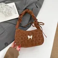 Brown leopard print underarm bag with silver bow buckle and ruched handle detail - Brown