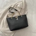 Large black tote bag with gold chain strap and deer pendant on white fabric - Black