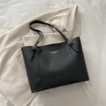 Minimalist black tote bag in faux leather with gold buckle detail and brand logo - Black