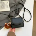 Black pebble leather crossbody bag with flap cover and cute brown plush monster pendant - With Pendant / Black